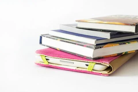 Close Up of an E-book reader in pink case covered with some old books Stock Photos