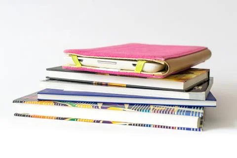 Close Up of an E-book reader in pink case on a pile of old books Stock Photos