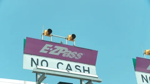 Close up of E-ZPass signage entering toll booth, day. Vídeo Stock 107618472