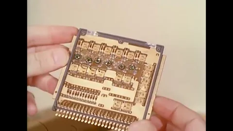 Close up of an early computer chip, computer chips are placed into an early Stock Footage 116044549