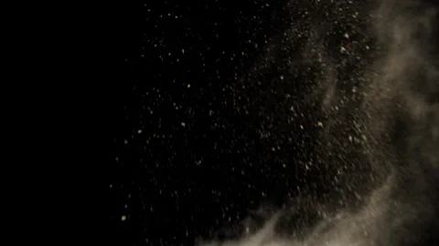 Close Up Earth Blast Shattering Sand Wave Against Black Background Stock Footage 336315455