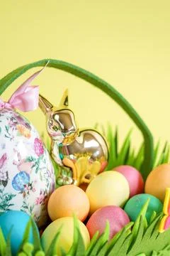 Close-up of an Easter Basket with Colorful Eggs and a Golden Bunny Stock Photos