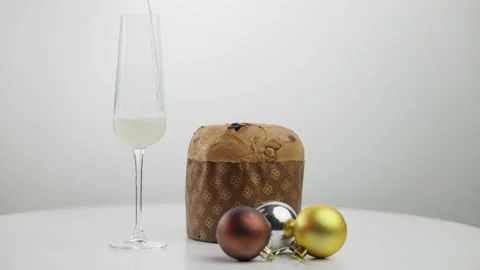 Close-up easter bread Paska on table and wine glass with champagne pouring Stock Footage 163801799