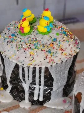 Close up of Easter cake with white icing and sprinkles Stock Photos