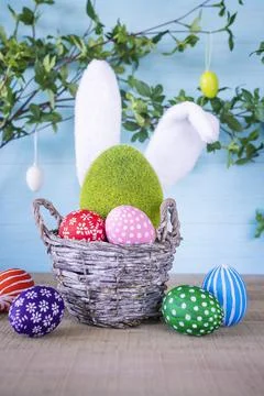 Close-up of Easter composition with basket with hand painted easter eggs. Stock Photos