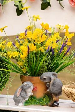 A close-up of an Easter decoration with small rabbits. Easter planters with y Stock Photos