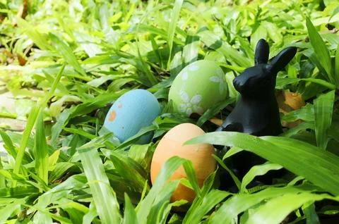 Close up of Easter eggs and rabbit decoration on green glass backgrounds Stock Photos