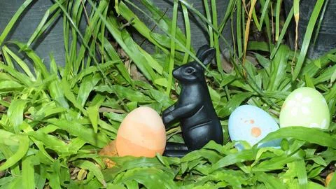 Close up of Easter eggs and rabbit decoration on green grass backgrounds Stock Photos