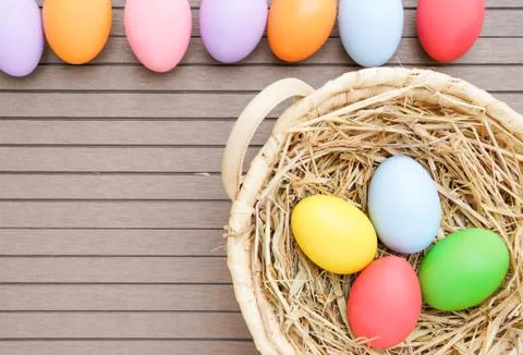 Close up Easter eggs in the basket on wood Stock Photos