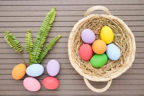 Close up Easter eggs in the basket on wood Stock Photos