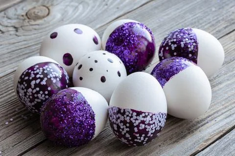 Close-up of Easter eggs decorated with purple sparkles. Stock Photos