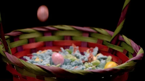 Close up easter eggs falling in basket slow and consistent Stock Footage 87692118