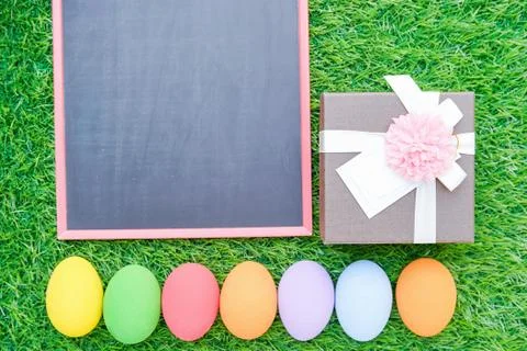 Close up Easter eggs on grass and blackboard mockup Stock Photos