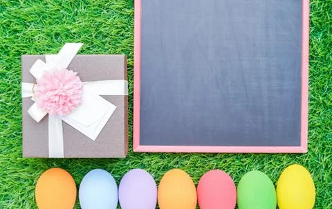Close up Easter eggs on grass and blackboard mockup Stock Photos