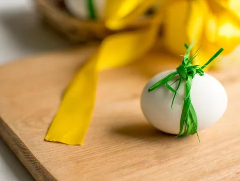 Close-up of Easter eggs tied with ribbon on white background. Фото