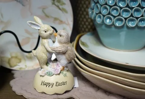 A close-up of an Easter figurine with a dancing rabbit and a chicken on a w.. Fotos de archivo