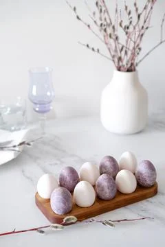 Close-up of Easter table setting with purple decorations, willow branches and Stock Photos