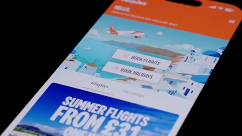Close-up of the EasyJet app being opened from a smartphone home screen and Stock Footage 334062970