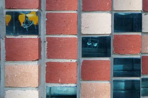 Close-up of an eclectic brick wall featuring red and beige bricks with inte.. Stock Photos