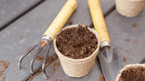 Close up of eco friendly biodegradable peat pots and garden tools, top view,  Stock Photos