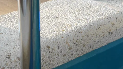 Close-up of the edge of an indoor overflow pool with mosaic concrete finish. The Stock Footage 312076947