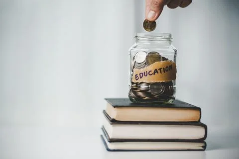 Close-up education object with stack money coin-cash dollar and glass jar on Foto stock