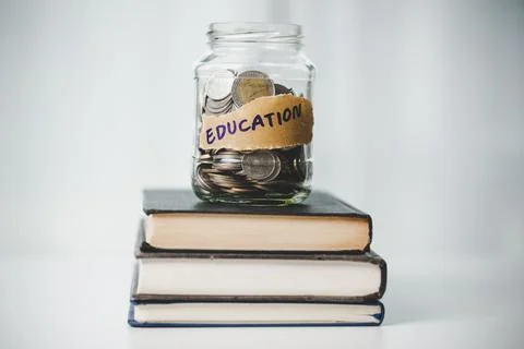 Close-up education object with stack money coin-cash dollar and glass jar on Stock Photos
