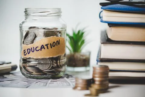 Close-up education object with stack money coin-cash dollar and glass jar on Stock Photos