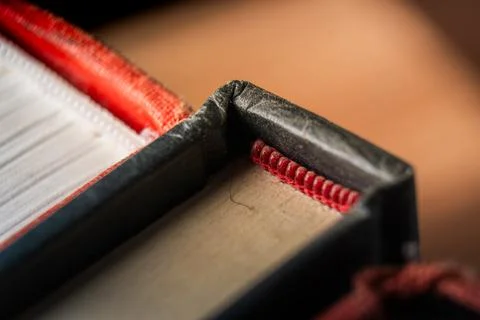 Close-up of an educational book showcasing its spine and pages in a warm, cozy Stock Photos