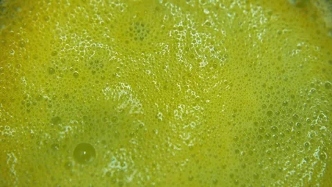 Close-up of an effervescent orange vitamin C tablet dissolving in water Stock-Footage 331742182
