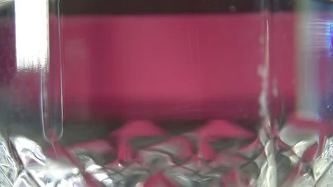 Close-up of effervescent tablet falling in glass of water Stock Footage 118087274