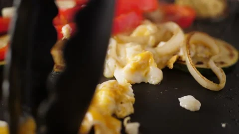 Close-up of an egg being prepared with tasty vegetables in a frying pan. 스톡 동영상 232086474