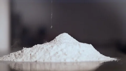 Close up of egg falling into flour Stock Footage 86465821