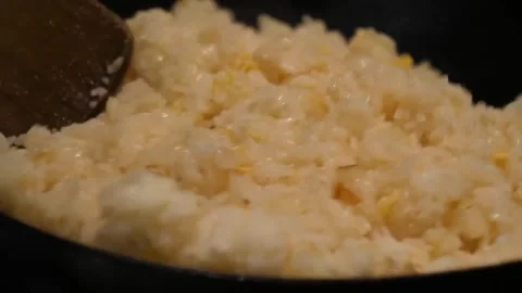 Close Up of Egg Fried Rice Being Stir Fried with Wooden Spatula in a Wok Stock-Footage 347689082