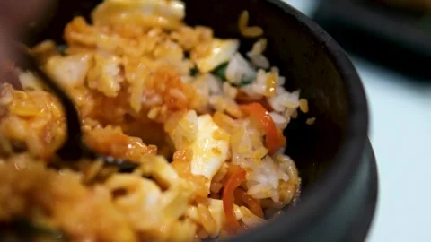 Close-up of egg fried rice with carrots and green peas, using spatula to stir Stock Footage 303856830