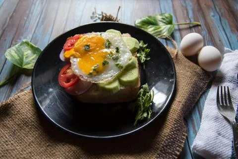 Close up of egg poach, salad condiments on bun bread Stock Photos