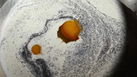 A close-up of an egg yolk. The process of preparing batter for pancakes. Pepper Stock Footage 264412803