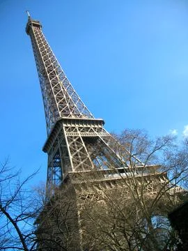 Close up of Eiffel tower against a bright blue sky in Paris, France Stock Photos