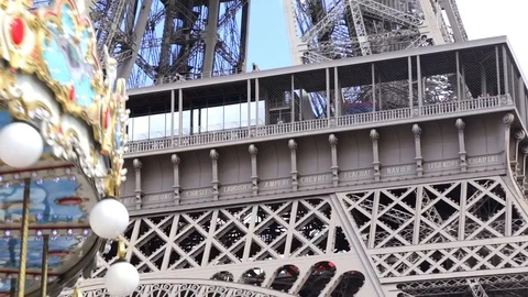 Close up of the Eiffel Tower and a spinning carousel in Paris France Stock Footage 105520137