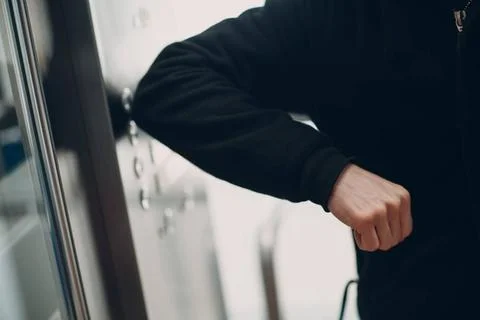 Close up of elbow pressing the button elevator during coronavirus pandemic... Stockfoto's