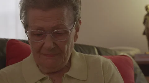 Close up of an elder woman's face while she's using a tablet computer Stock Footage 44982648
