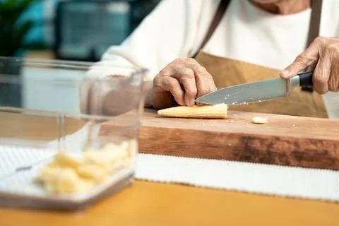 Close-up, Elderly are cooking in the kitchen at home, cutting vegetables an.. Stock Photos