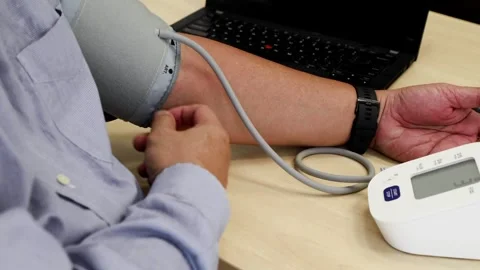 Close up of elderly Asian man measuring own blood pressure with instrument in Stock Footage 263039645