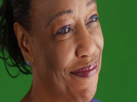 A close-up of an elderly black woman looking into the distance on green screen Stock Footage