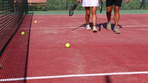 Close-up of an elderly couple's legs as they walk on the tennis court, hold.. Stock Footage 290353719