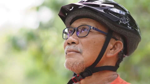 Close-up of Elderly Cyclist with Helmet Looking Thoughtfully Stock Footage 272217468