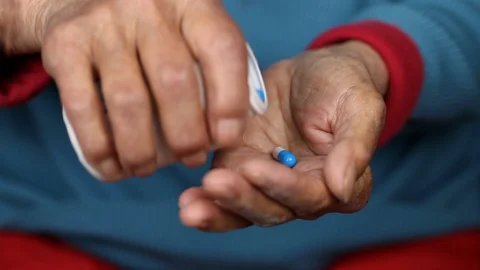Close up of elderly female taking pills out of medicine pill box Stock Footage 108540801