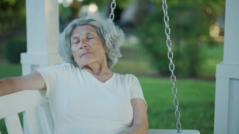 Close on elderly German woman napping on backyard swing, feeling relaxed 스톡 동영상 248081663