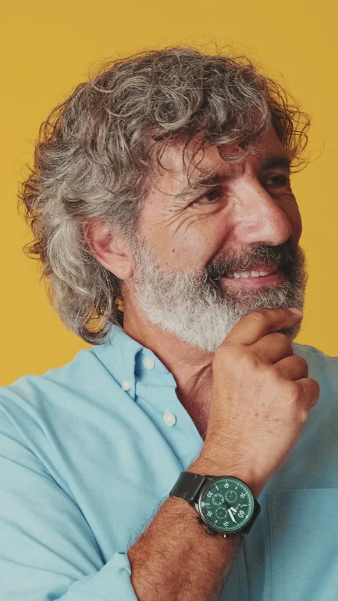 Close up, elderly gray-haired man, looking camera, thinking pleasantly, smiling, Stock Footage 250463509