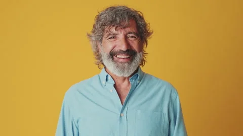 Close up, elderly gray-haired man, looking at camera and laughing, isolated on Video stock 250841398
